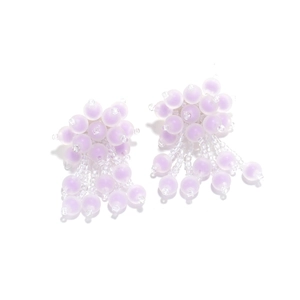 Detailed macro view of lavender frosted beads and handmade flower tassel earring design