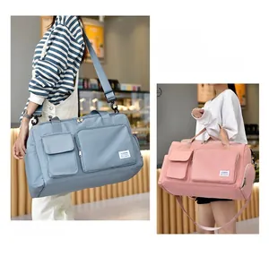 Detail of waterproof nylon travel bags in light blue and pink with multiple pockets