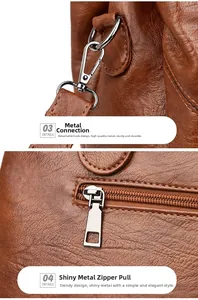 Detailed silver hooks and metal zipper pulls on a brown leather shoulder bag