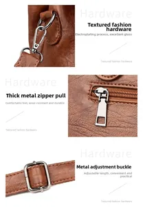 Detail view of silver metal hardware on brown lychee pattern leather shoulder bag