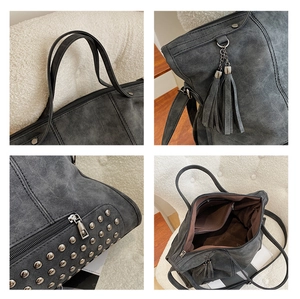 Detail view of rivets, tassel charm, and spacious interior of the retro grey tote bag