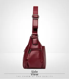 Side view of dark red crossbody bag with litchi texture and adjustable shoulder strap