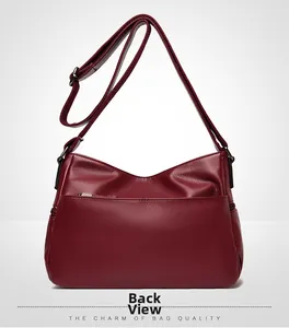 Back view of dark red lychee leather crossbody bag with zipper pocket and strap