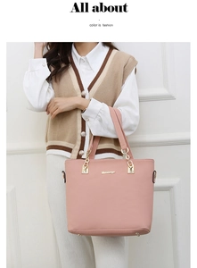 Pink leather tote bag detail with gold chain and Meisiage logo on elegant model