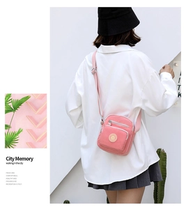 Pink nylon crossbody bag with multi-zipper pockets and adjustable strap for women