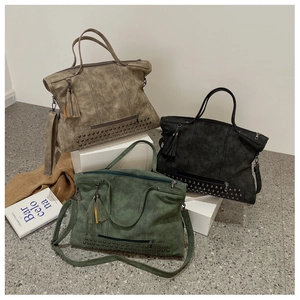 Three vintage tote bags in khaki, black, and green with studs and tassel details