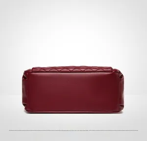 Detail view of the deep red quilted leather base and fine stitching on the women bag