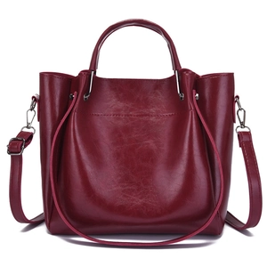 Deep wine red faux leather tote bag with top handles and adjustable shoulder strap