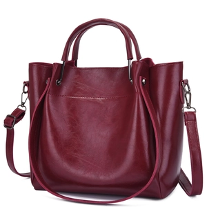Deep red patent leather tote bag with round handles and adjustable shoulder strap