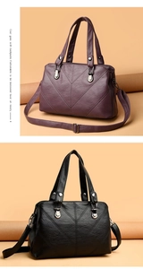 Detail of quilted leather tote bag with V-shaped stitching and metal hardware in purple and black