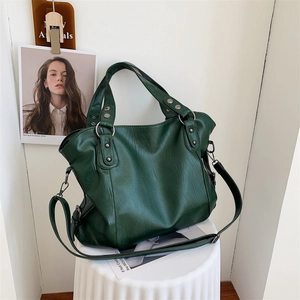 Large dark green tote bag in pebbled faux leather with metal rivets and strap