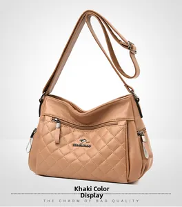 Close-up of khaki faux leather crossbody bag with rhombus stitching and kangaroo logo