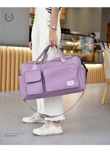 Detail of light purple waterproof nylon travel bag with front pockets and branding