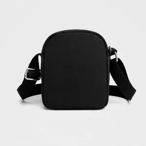 Rear view of the black Oxford cloth crossbody bag with adjustable strap and metal hardware