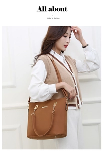 Detail of caramel brown tote bag with gold Meids logo and adjustable chain strap
