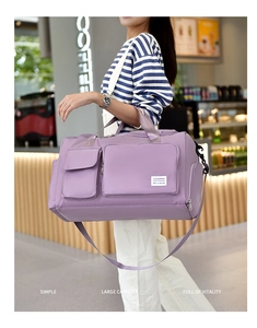 Close-up of purple waterproof travel bag with adjustable strap and multiple storage pockets
