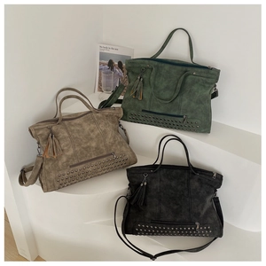 Three vintage tote bags in green, khaki, and black featuring rivets and tassel details