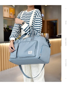 Detail of waterproof nylon travel bag in blue with multi-pocket and shoulder strap