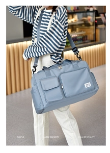 Close-up of waterproof travel bag with multiple pockets and adjustable shoulder strap