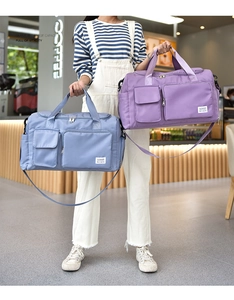 Close-up of waterproof nylon travel bag details with multiple zipper pockets and straps