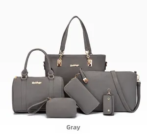 Detail view of 6-piece grey leather handbag set with gold zippers and metal hardware