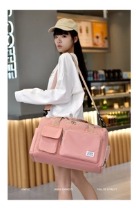 Pink waterproof travel bag shown with model in a cafe setting, high capacity design