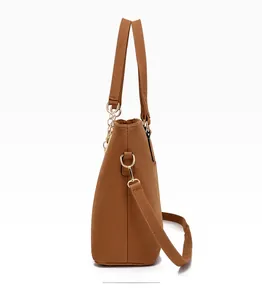 Side view of brown large tote bag with adjustable shoulder strap and gold hardware detail