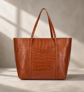 Detailed view of brown faux-leather tote bag with elegant crocodile embossed texture