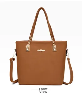 Front view of matte camel tote bag with golden metal logo and cylindrical handles