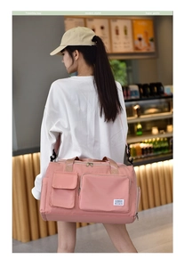 Detail of pink waterproof travel bag with multi-pockets and adjustable shoulder strap