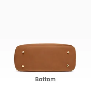 Detailed bottom view of brown leather tote bag with four gold protective metal feet