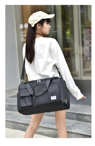 Detail view of large capacity waterproof travel bag with side pockets and shoulder strap