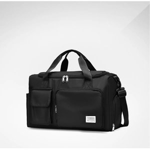 Detail view of large waterproof travel bag with reinforced handles and brand patch
