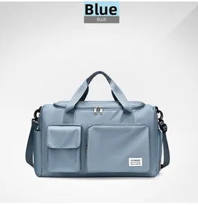 Blue high-density nylon travel bag with dual handles and adjustable shoulder strap detail