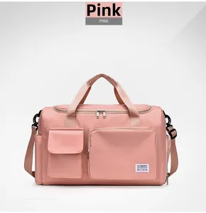 Detail view of pink waterproof nylon travel bag with logo and functional front pockets