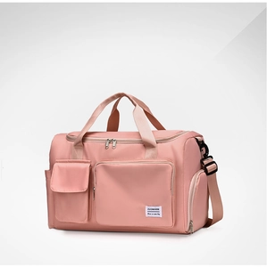 Detail of pink waterproof nylon travel bag with adjustable strap and multi-pocket design