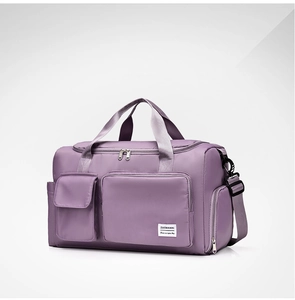 Detail view of purple waterproof nylon gym bag featuring multi-pocket design and strap