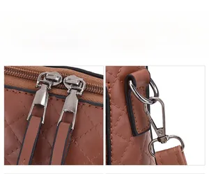Détails de la texture en cuir matelassé marron et double fermeture éclair du sac