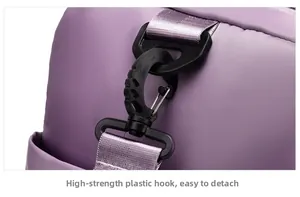 Close-up of durable black plastic swivel hook and purple nylon strap for travel bag
