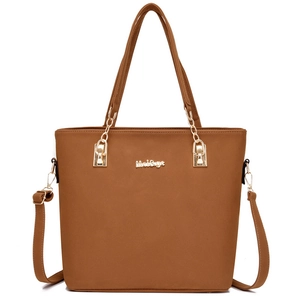 Brown leather tote bag with gold chain and adjustable strap on a clean white background