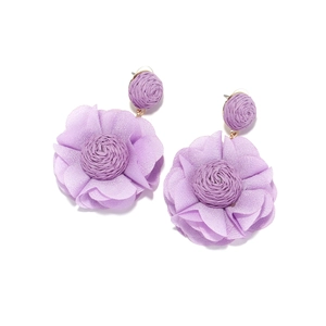 Detail of lavender chiffon flower earrings with handcrafted raffia woven centers