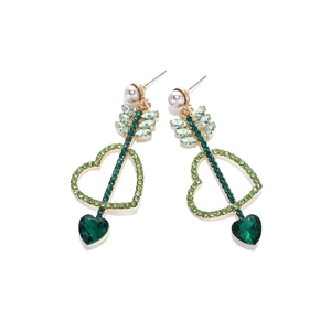 Détail des boucles d'oreilles cœur flèche de Cupidon avec cristaux verts et perles nacrées