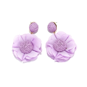 Detailed macro view of purple fabric flower earrings with woven spiral center design