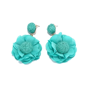 Detail view of handmade layered chiffon flower earrings in seafoam green with raffia core