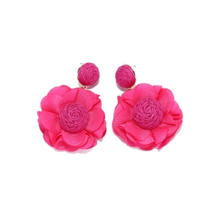 Detail of rose pink fabric flower earrings featuring layered chiffon petals and gold studs