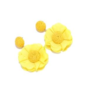 Macro shot of layered yellow chiffon flower earrings with raffia woven core detailing