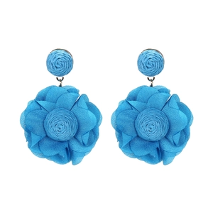 Detailed view of handcrafted bright blue chiffon flower earrings with raffia woven centers