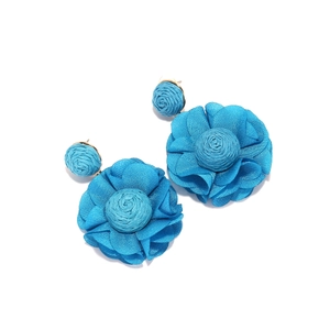 Detail of blue chiffon flower earrings with handcrafted raffia woven petals and golden studs