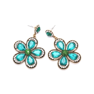 Close-up of green water-drop crystals and white pavé rhinestones on flower earrings