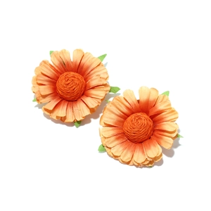 Macro view of handmade orange fabric sunflower earrings with gradient petals and green leaves